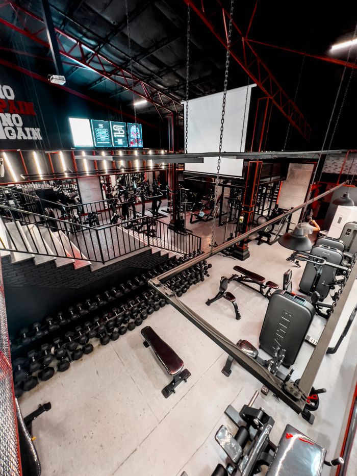 our-value Spacious gym interior featuring a variety of fitness equipment and weights, perfect for workouts.
